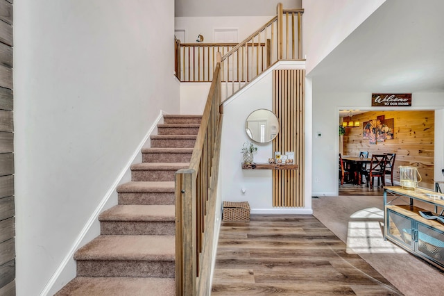 291 White Pine Dr, Pocono Lake, PA 18347 - stairs featuring wooden walls, baseboards, and wood finished floors