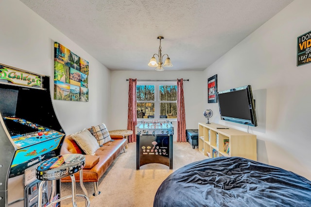 carpeted bedroom featuring a chandelier and a textured ceiling