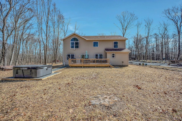 back of house featuring a deck, central air condition unit, and a hot tub