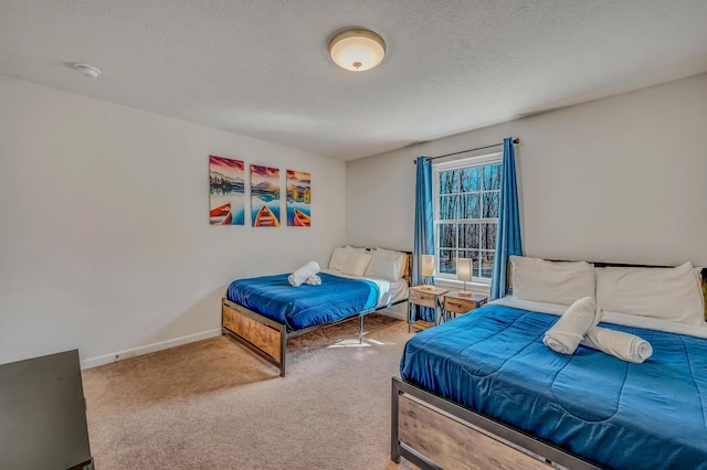 bedroom featuring baseboards, carpet, and a textured ceiling