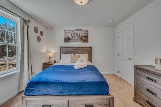 carpeted bedroom with baseboards and multiple windows