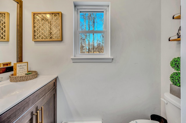 half bathroom with toilet and vanity