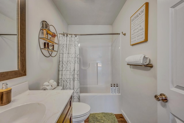 full bath featuring toilet, shower / bath combo, vanity, and a textured ceiling