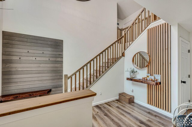 291 White Pine Dr, Pocono Lake, PA 18347 - stairway with baseboards, wood finished floors, and a towering ceiling