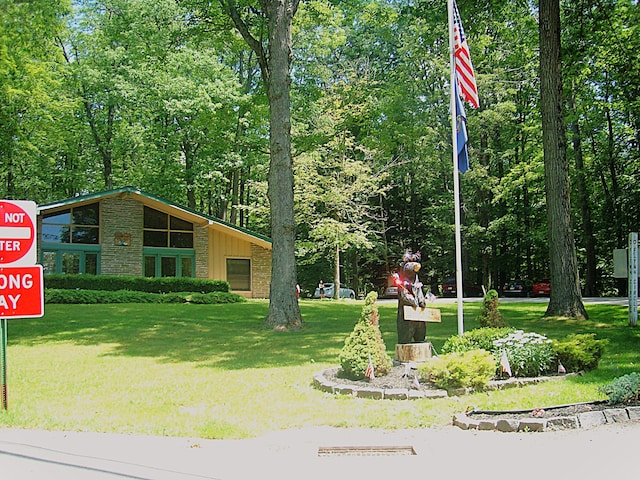 view of property's community with a lawn