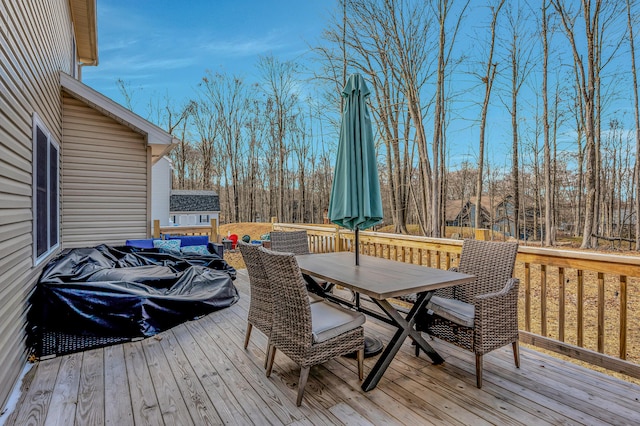 wooden deck featuring outdoor dining area