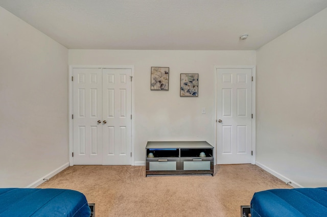 bedroom with a closet, baseboards, and carpet