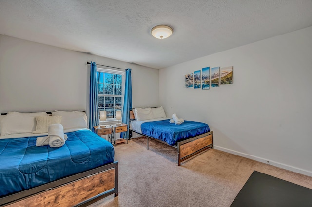 bedroom featuring baseboards, carpet floors, and a textured ceiling