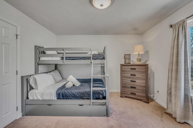 carpeted bedroom featuring baseboards and a textured ceiling