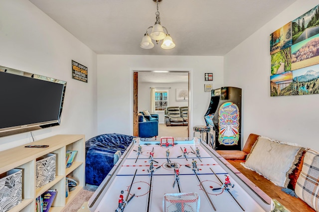 game room with a chandelier