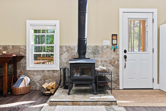 interior details featuring hardwood / wood-style floors and a wood stove