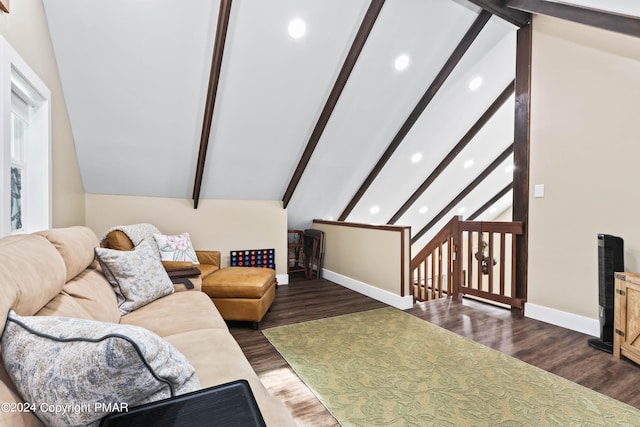 living room featuring vaulted ceiling with beams and dark hardwood / wood-style floors