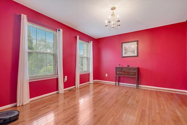 706 Franklin Ct, East Stroudsburg, PA 18302 - unfurnished room featuring a chandelier and wood-type flooring