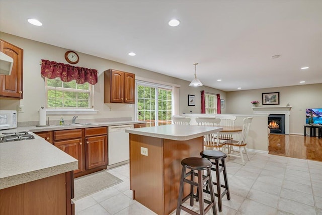 706 Franklin Ct, East Stroudsburg, PA 18302 - kitchen with white appliances, a breakfast bar, light countertops, a kitchen island, and recessed lighting