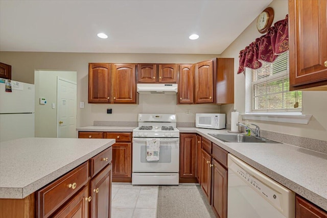 706 Franklin Ct, East Stroudsburg, PA 18302 - kitchen with white appliances, under cabinet range hood, brown cabinets, light countertops, and light tile patterned floors