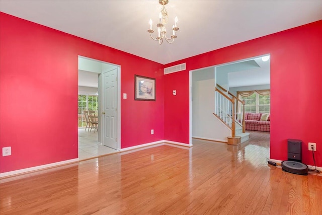 706 Franklin Ct, East Stroudsburg, PA 18302 - empty room featuring a chandelier, wood finished floors, and stairway