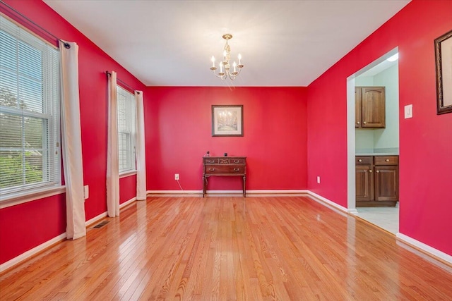 706 Franklin Ct, East Stroudsburg, PA 18302 - spare room featuring light wood-type flooring and a chandelier