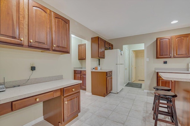 706 Franklin Ct, East Stroudsburg, PA 18302 - kitchen featuring freestanding refrigerator, light countertops, brown cabinets, and recessed lighting