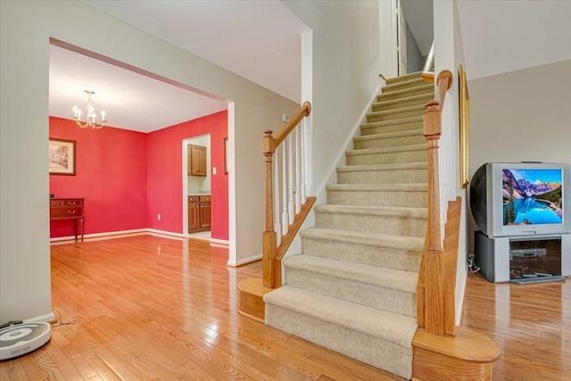 706 Franklin Ct, East Stroudsburg, PA 18302 - staircase featuring wood finished floors and a chandelier