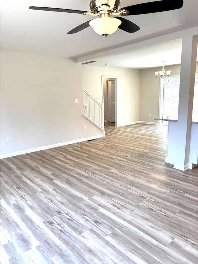 20 Leaf Ct, East Stroudsburg, PA 18302 - spare room with a ceiling fan, wood finished floors, a chandelier, stairway, and baseboards