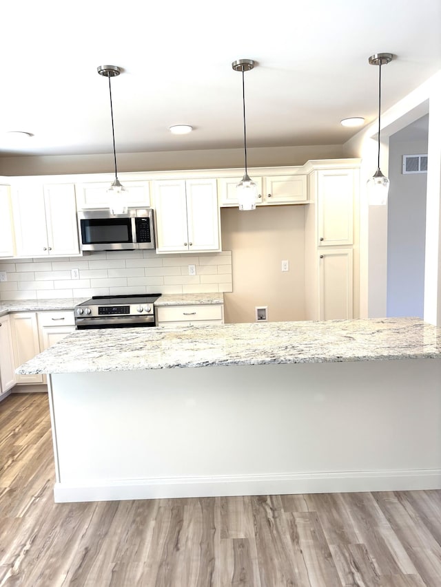 20 Leaf Ct, East Stroudsburg, PA 18302 - kitchen with appliances with stainless steel finishes, light stone counters, tasteful backsplash, and light wood-style flooring
