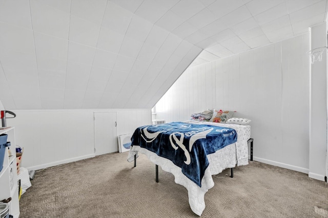 carpeted bedroom with baseboards and lofted ceiling