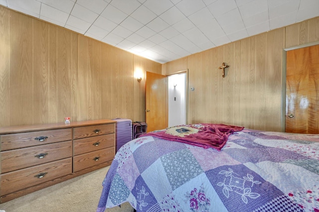 carpeted bedroom with wooden walls