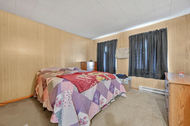 bedroom featuring carpet floors, wooden walls, and a baseboard radiator