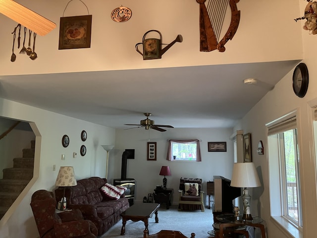 20 Horseshoe Dr, White Haven, PA 18661 - carpeted living area with a wood stove, healthy amount of natural light, ceiling fan, and stairs