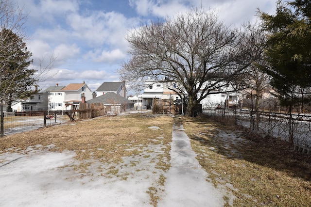 view of yard featuring a residential view and fence