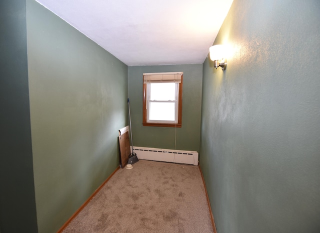 unfurnished room featuring carpet floors, baseboards, and baseboard heating