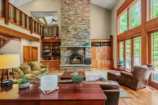 44 Watawga Way W, Gouldsboro, PA 18424 - living room with high vaulted ceiling, wood finished floors, ceiling fan, and a stone fireplace