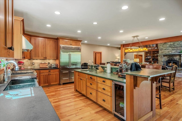 44 Watawga Way W, Gouldsboro, PA 18424 - kitchen with beverage cooler, stainless steel built in fridge, a sink, exhaust hood, and light wood-style flooring
