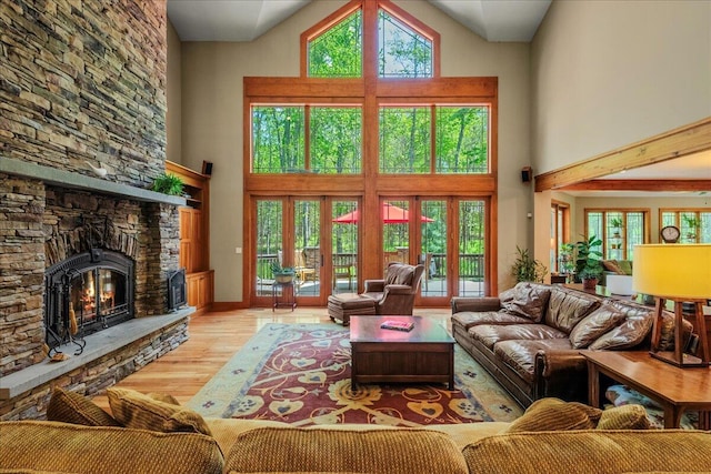44 Watawga Way W, Gouldsboro, PA 18424 - living room featuring a high ceiling, wood finished floors, french doors, a fireplace, and baseboards
