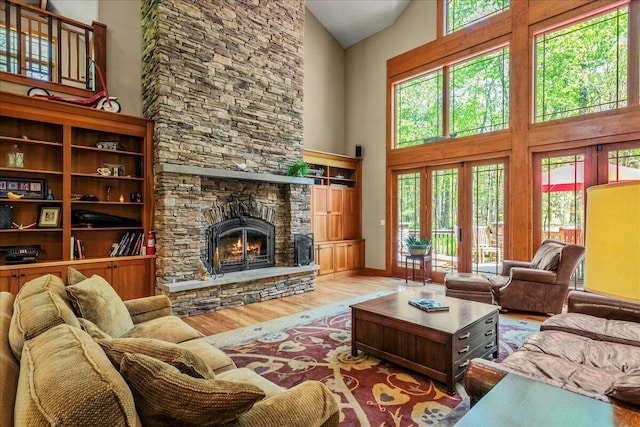 44 Watawga Way W, Gouldsboro, PA 18424 - living area featuring high vaulted ceiling, wood finished floors, a stone fireplace, and baseboards