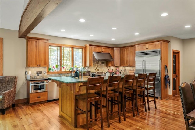 44 Watawga Way W, Gouldsboro, PA 18424 - kitchen featuring appliances with stainless steel finishes, under cabinet range hood, light wood-style floors, recessed lighting, and decorative backsplash