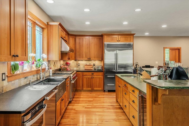 44 Watawga Way W, Gouldsboro, PA 18424 - kitchen featuring premium appliances, under cabinet range hood, a sink, wine cooler, and dark countertops