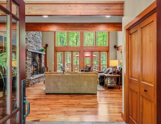 44 Watawga Way W, Gouldsboro, PA 18424 - living area featuring beam ceiling, light wood-style flooring, a fireplace, a towering ceiling, and french doors