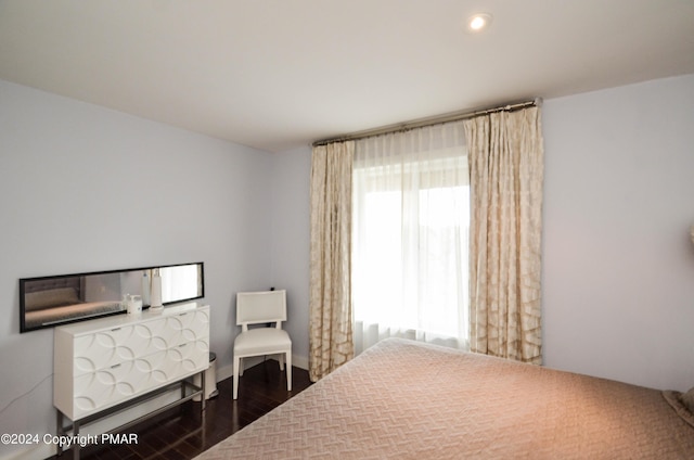 bedroom with recessed lighting and dark wood finished floors