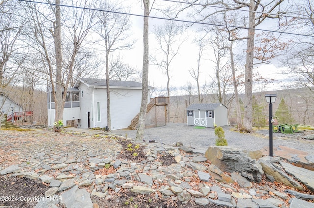 exterior space with a storage shed and an outdoor structure