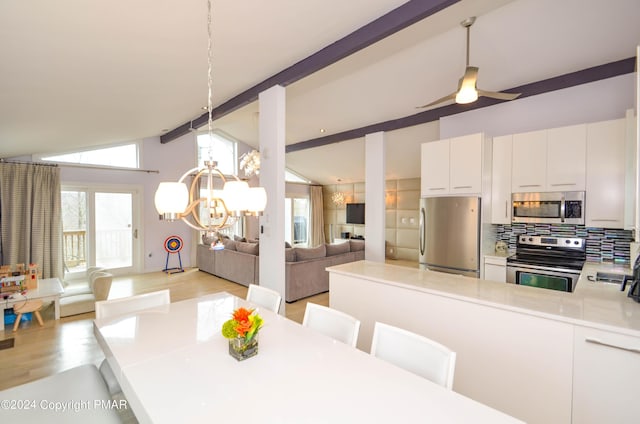 dining area featuring lofted ceiling with beams, light wood-style floors, and ceiling fan with notable chandelier