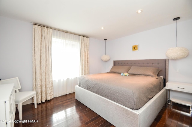 bedroom with wood finished floors and recessed lighting