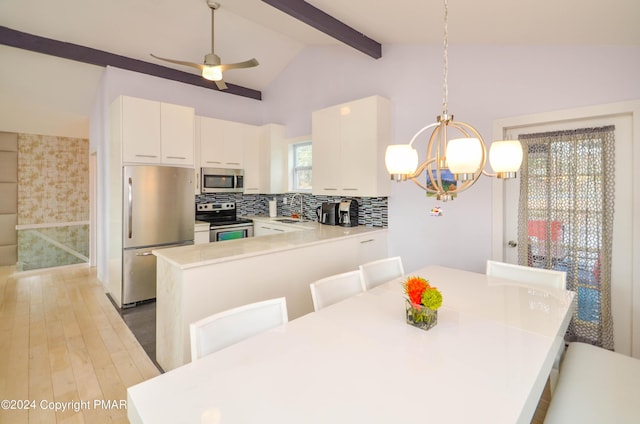 dining room with lofted ceiling with beams, light wood-style flooring, and ceiling fan with notable chandelier