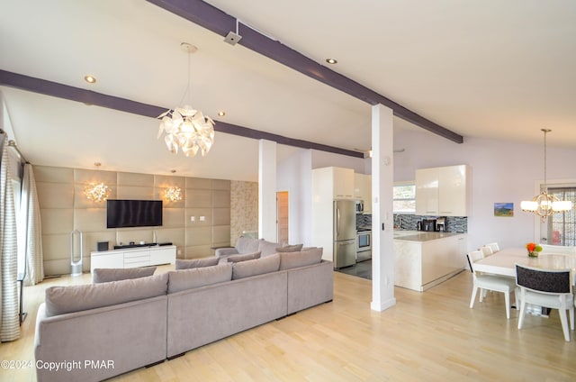 living area featuring lofted ceiling with beams, light wood-type flooring, and an inviting chandelier