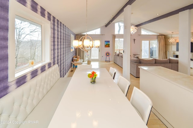 dining area featuring lofted ceiling with beams, wallpapered walls, an accent wall, and an inviting chandelier