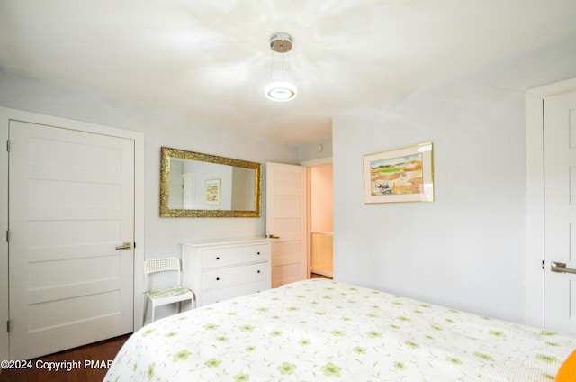 bedroom with dark wood-style flooring