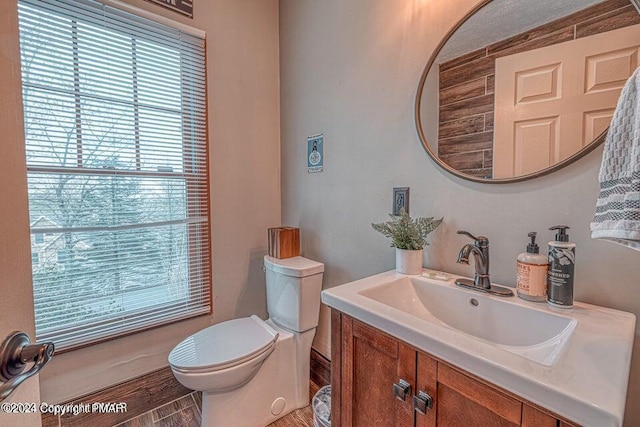 half bathroom with vanity and toilet