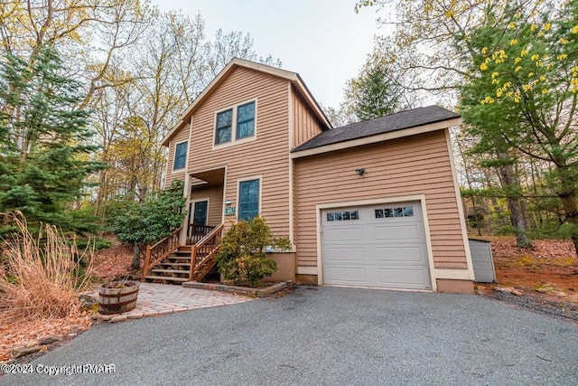 view of front of house with aphalt driveway and a garage