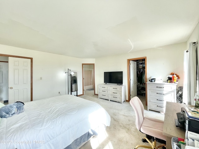 bedroom featuring light carpet, a walk in closet, and a closet