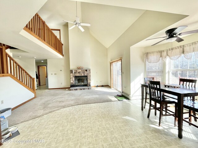 living room with high vaulted ceiling, light carpet, a fireplace, and ceiling fan